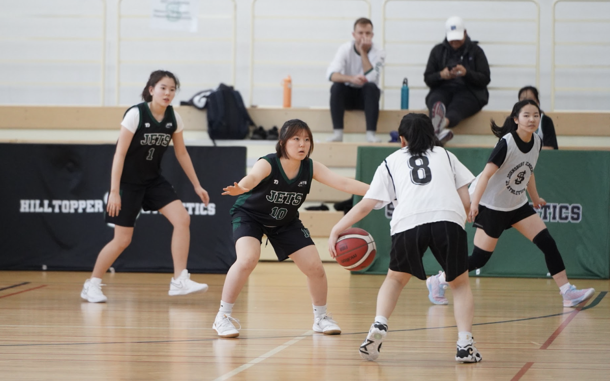 Sophomore Victoria Kang (number 10) closes out with intensity, locking down her opponent and disrupting the play. Her defensive stance keeps the team in control.